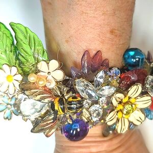 Wendy Gell pretty little garden cuff. Ladybug flowers, leaves jewels.